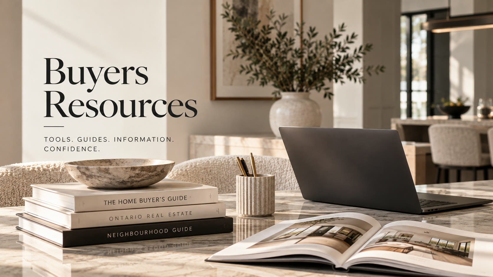 Real estate guides beside a laptop